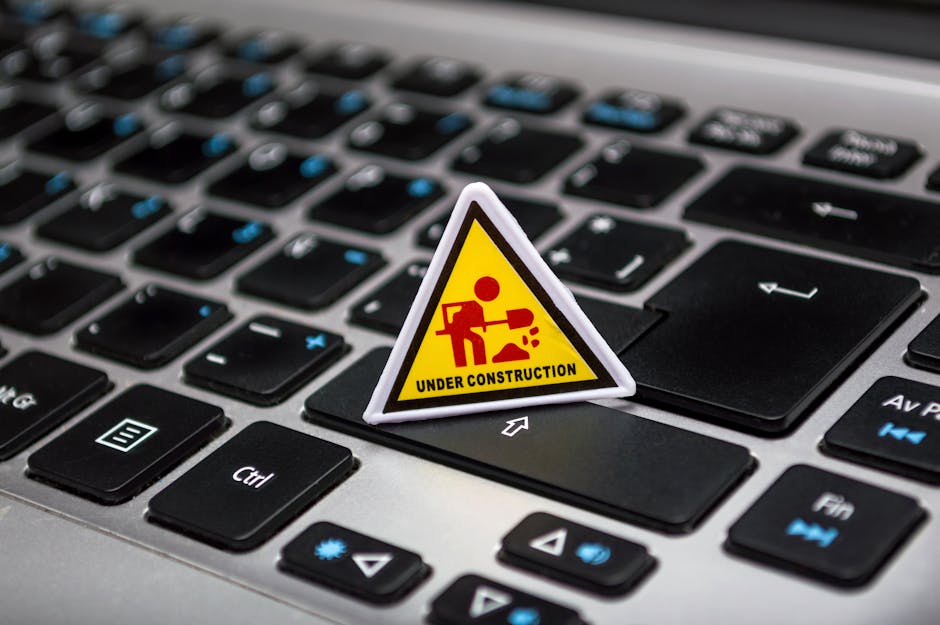 Laptop showing security alert while a person takes urgent protective steps