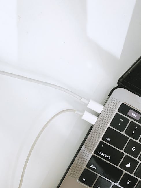 Laptop connected to a USB-C charger showing charging status