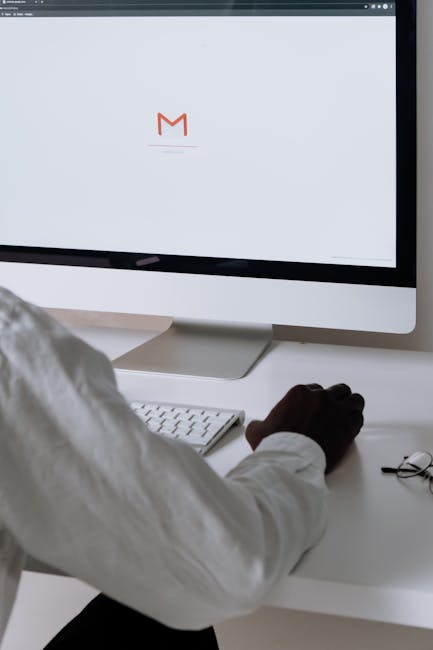Person reviewing an email on a phone, highlighting caution before clicking links