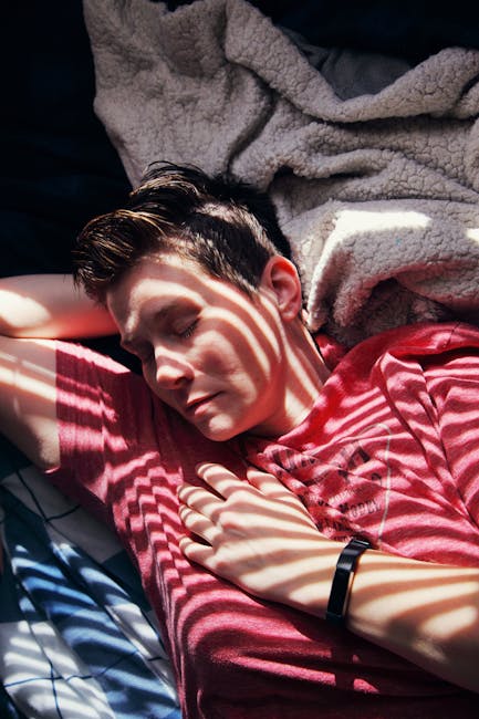 Person wearing a smartwatch while sleeping, showing sleep and recovery focus.
