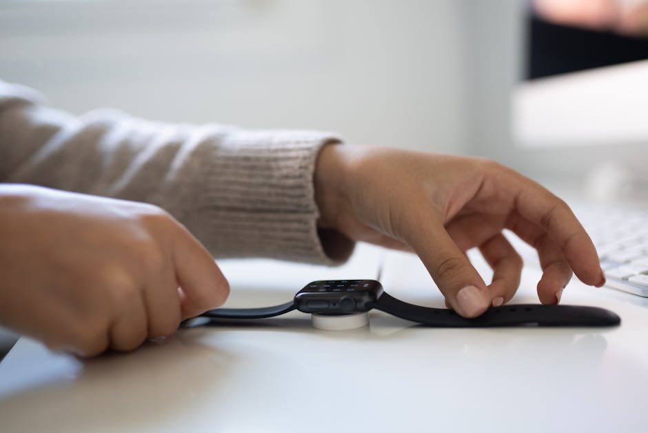 Smartwatch charging on a dock, illustrating battery and charging habits for accurate tracking.