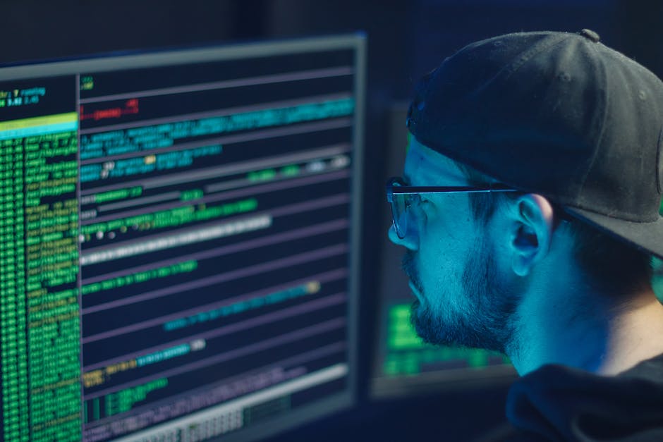 Security analyst monitoring alerts on multiple screens in an office setting