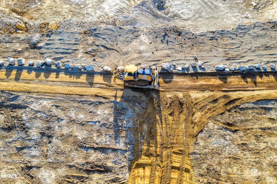 Pexels photo showing earthmoving equipment for estimating time and cost from grading to transport using practical tech metrics