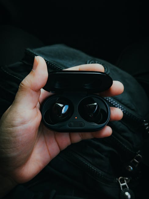 Gadget Review: Latest wireless earbuds on a desk, showing mic quality, latency, and battery life testing.
