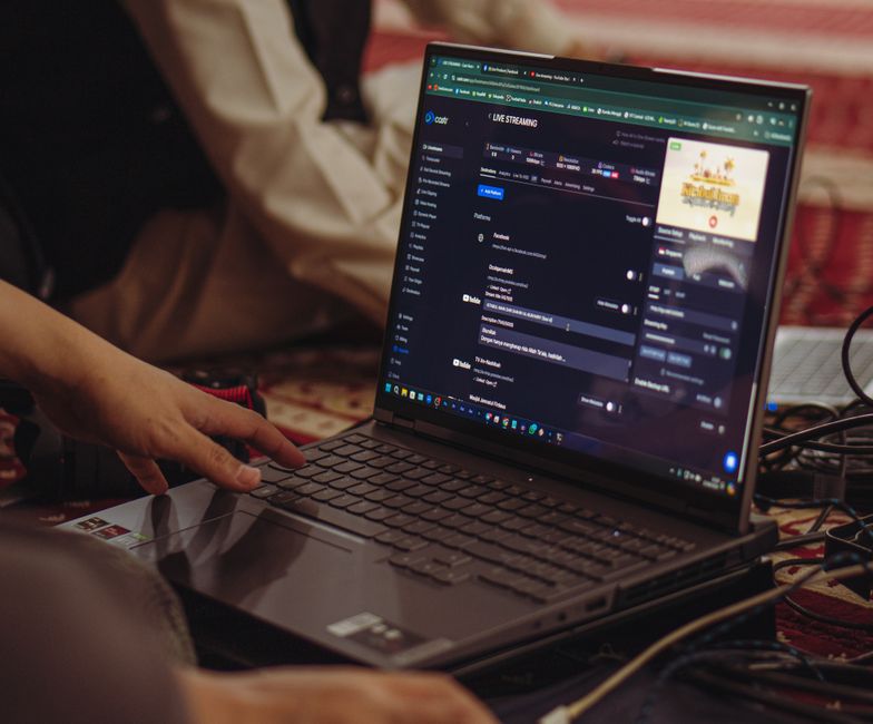 Person using a laptop with live captions and AI-assisted camera effects
