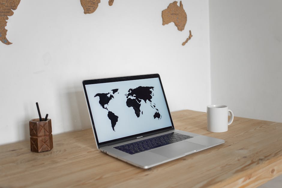 Person using a laptop with portable SSD connected while traveling in a hotel or café