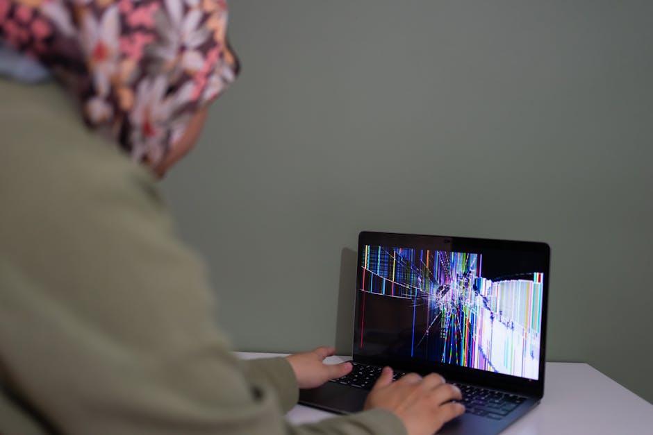 Person checking laptop display settings and ports after an external monitor shows black screen