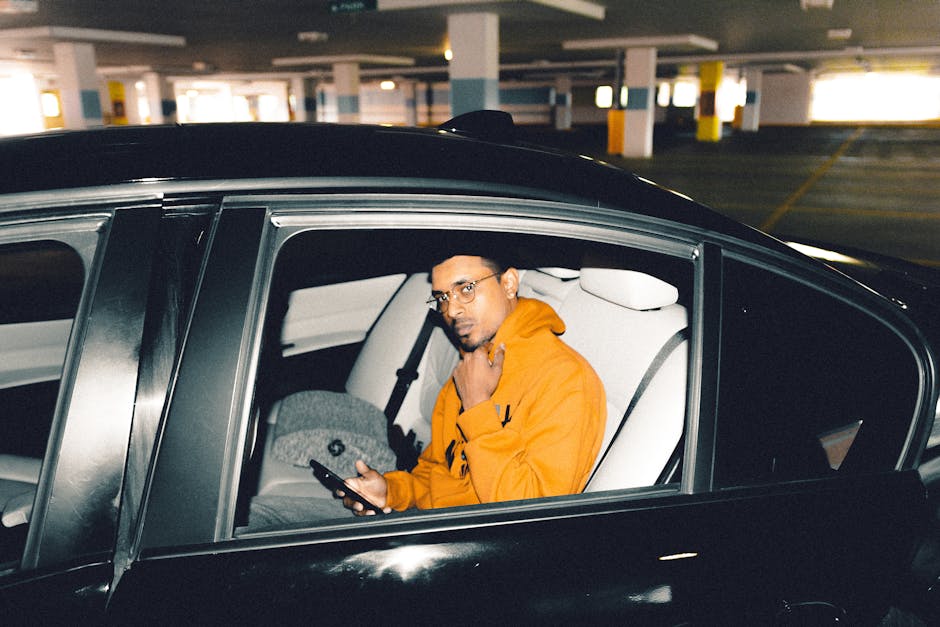 Driver adjusting music streaming on phone mount in a car, focusing on low-delay playback