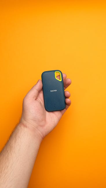 Portable SSD on a workbench with protective case after controlled handling checks