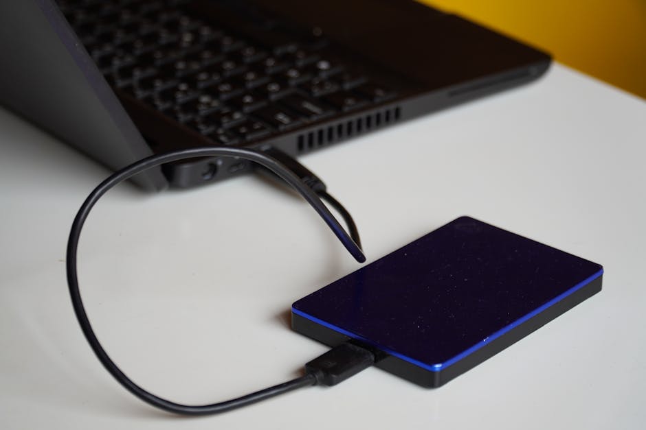 Laptop transferring files to an external drive via USB-C, illustrating data speed differences