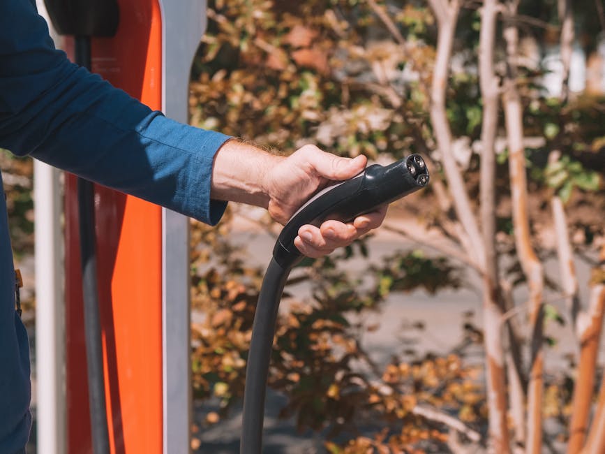 Portable power station charging from wall outlet with visible cables and outlets