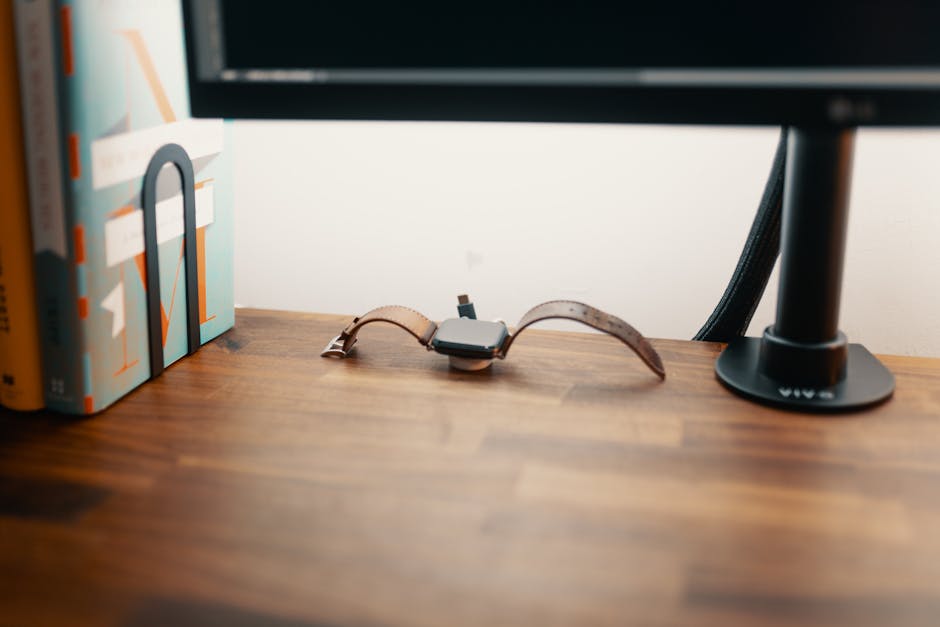 Smartwatch resting near a charging cable on a bedside table