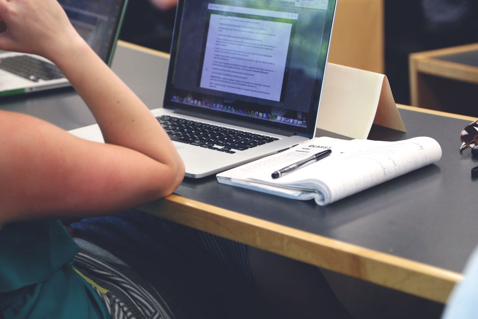 Student working on a budget laptop with school documents and tabs